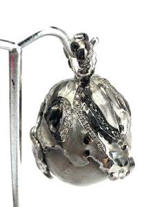 Natural blue south sea pearl with 18k white gold , rhodium and white / black diamonds .