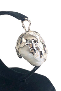 Natural blue south sea pearl with 18k white gold , rhodium and white / black diamonds .