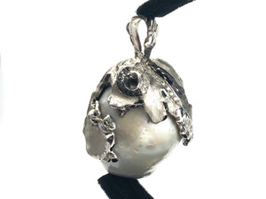 Natural blue south sea pearl with 18k white gold , rhodium and white / black diamonds .