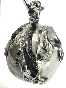 Natural blue south sea pearl with 18k white gold , rhodium and white / black diamonds .